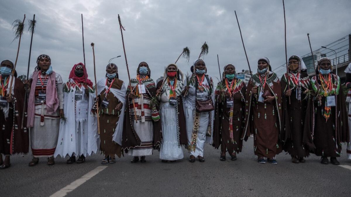Women, wearing traditional clothing, sing and march during the celebration of “Irreechaa”, the Oromo people thanksgiving holiday, in Addis Ababa, Ethiopia, on October 3, 2020.  EDUARDO SOTERAS / AFP