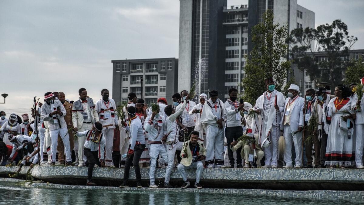 People spray water as part of the celebration of “Irreechaa”, the Oromo people thanksgiving holiday, in Addis Ababa, Ethiopia, on October 3, 2020. EDUARDO SOTERAS / AFP