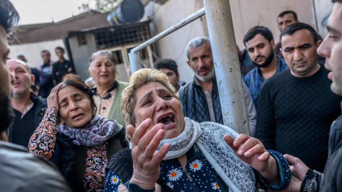Women react as rescuers search for victims or survivors at the blast site hit by a rocket during the fighting between Armenia and Azerbaijan over the breakaway region of Nagorno-Karabakh, in the city of Ganja, Azerbaijan, on October 11, 2020. Bulent Kilic / AFP