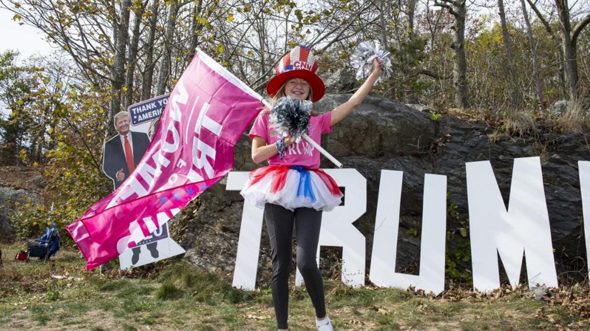 People dressed in political costumes participate in a contest during a Trump campaign rally named "Trumptoberfest" at Rocky Point Park in Warwick, Rhode Island on October 11, 2020. Many supporters dressed in political campaign clothing and waved flags while others dressed in festive costumes to take part in a political costume contest. Joseph Prezioso / AFP