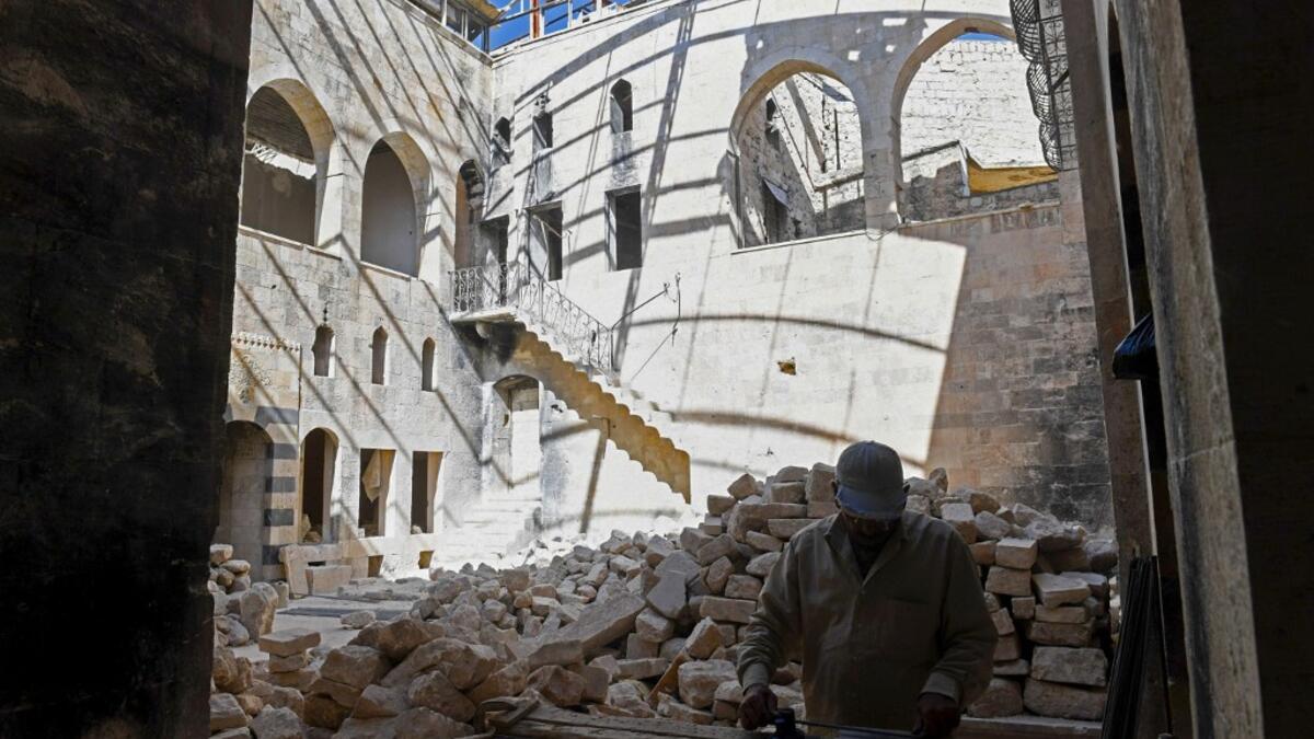 Syrian workers take part in the reconstruction of Martini restaurant and hotel in the Jdaideh neighbourhood in Aleppo's Old City on October 17, 2020. AFP