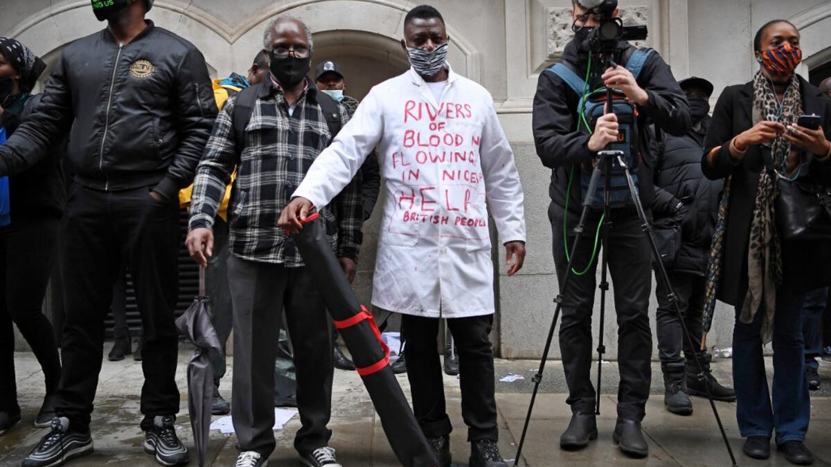 Protestors attend a demonstration outside the Nigerian High Commission against police brutality in Lagos in London on October 21, 2020. UN Secretary General Antonio Guterres called Wednesday for an end to what he called "brutality" by police in Nigeria, which has been rocked by two weeks of protests. Guterres said gunmen that opened fire on peaceful protesters Tuesday evening in Lagos caused "multiple deaths" and many injuries. Daniel LEAL-OLIVAS / AFP