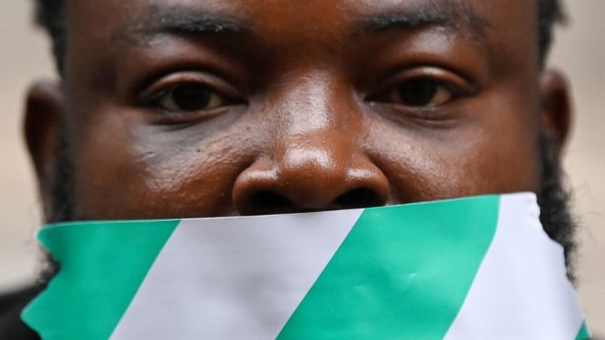 Protestors attend a demonstration outside the Nigerian High Commission against police brutality in Lagos in London on October 21, 2020. UN Secretary General Antonio Guterres called Wednesday for an end to what he called "brutality" by police in Nigeria, which has been rocked by two weeks of protests. Guterres said gunmen that opened fire on peaceful protesters Tuesday evening in Lagos caused "multiple deaths" and many injuries. DANIEL LEAL-OLIVAS / AFP