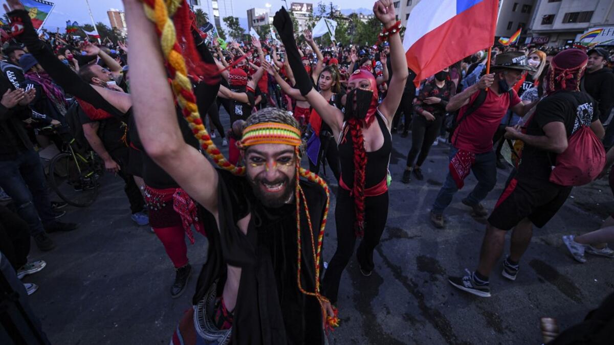 Demonstrators supporting the reform of the Chilean constitution gather waiting for the referendum official results at Plaza Italia square in Santiago on October 25, 2020. The campaign to replace Chile's dictatorship-era constitution held a big lead in Sunday's referendum, partial results showed. The "Approve" vote to throw-out a constitution seen as underpinning the nation's glaring inequalities led by 77.26 percent to 22.74 percent, with 11 percent of the votes counted.  MARTIN BERNETTI / AFP