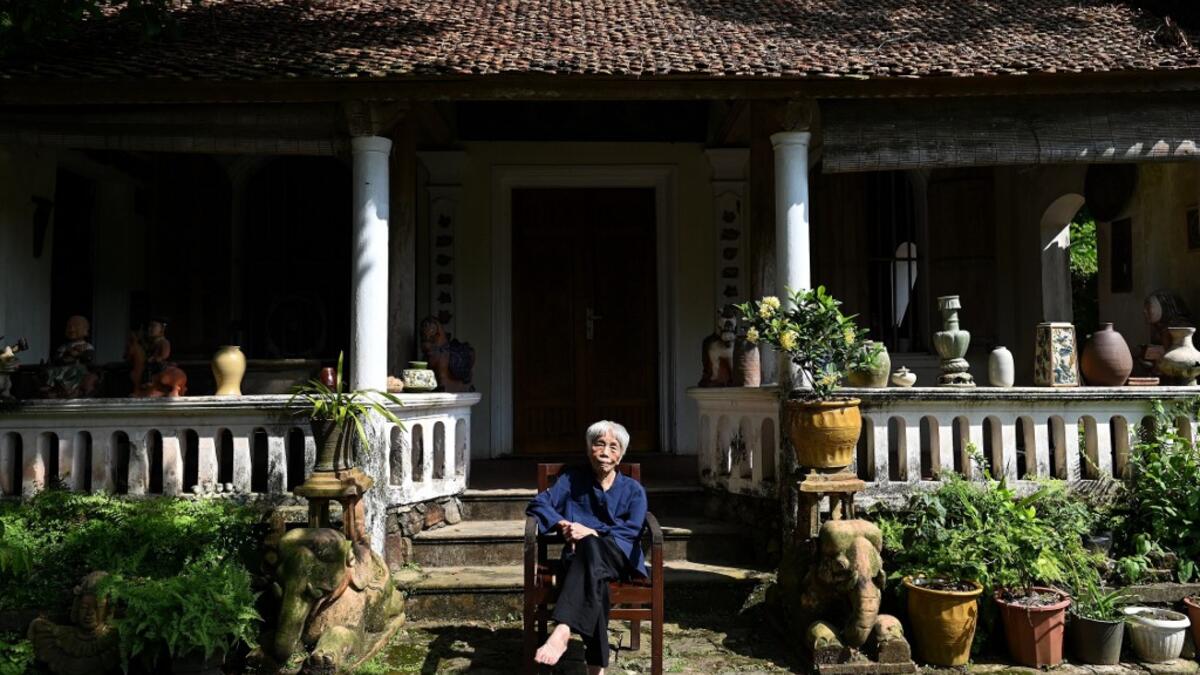 This photograph taken on October 22, 2020 shows 89-year-old Vietnamese artist Mong Bich addressing guests during the opening of her first solo exhibition at the French Cultural Centre in Hanoi. Bich specialises in silk paintings of daily life and ordinary people, women in particular, and ploughed a lonely furrow during many years of war when artists were steered towards the army or frontline workers as subjects. Manan VATSYAYANA / AFP
