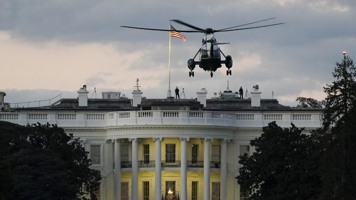 U.S. Marine One, with President Donald Trump onboard, prepares to land on the South Lawn of the White House on October 5, 2020 in Washington, DC. Trump was returning to the White House after being treated for Covid-19 at Walter Reed National Military Medical Center. Drew Angerer/Getty Images/AFP Drew Angerer / GETTY IMAGES NORTH AMERICA / Getty Images via AFP