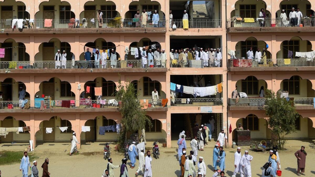 In this picture taken on October 19, 2020 Islamic seminary students gather in the premises of the hostel at the Darul Uloom Haqqania seminary in Akora Khattak which has churned out a who's who of Taliban top brass -- including many now on the hardline group's negotiating team holding talks with the Kabul government to end a 20-year war. Abdul MAJEED / AFP