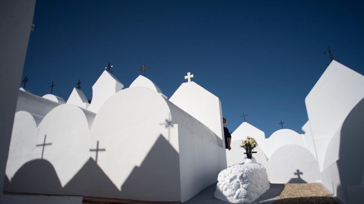 A woman visits the grave of a relative at the cemetery of Casabermeja, southern Spain, on October 30, 2020 on the eve of All Saint's Day amid the coronavirus pandemic. JORGE GUERRERO / AFP