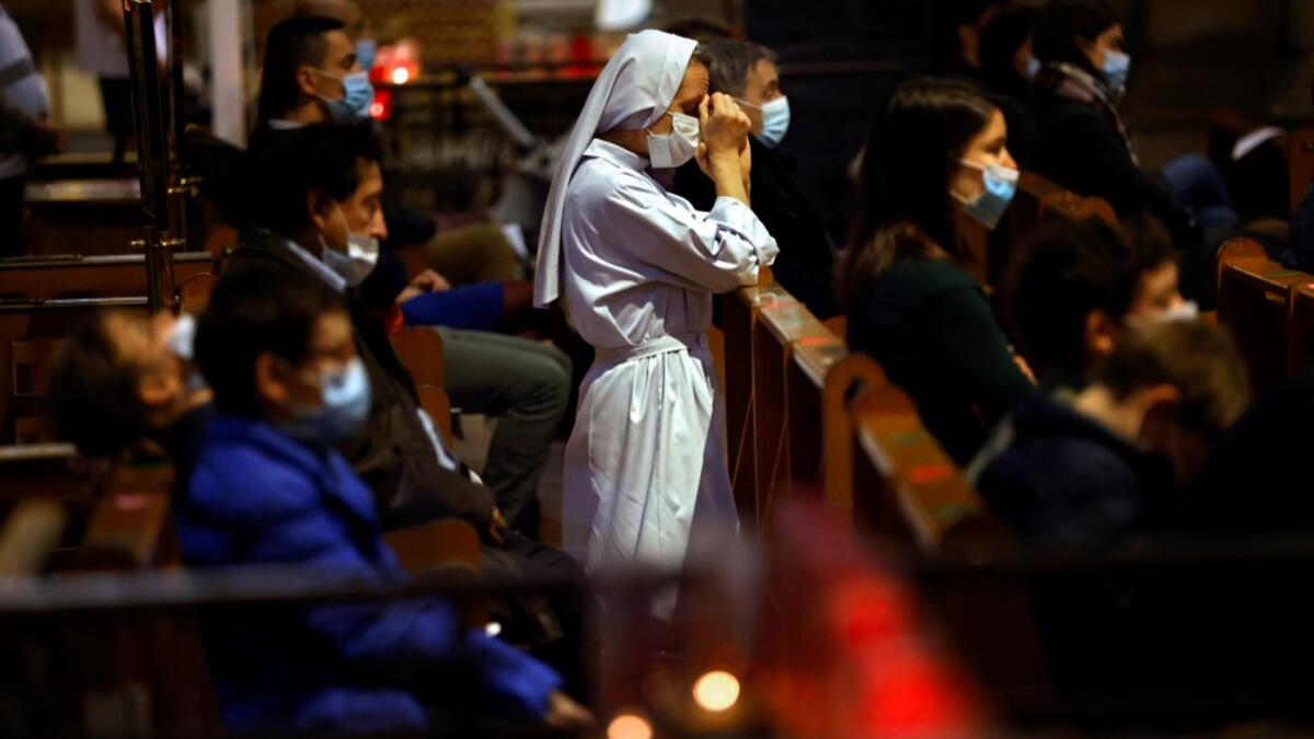 A nun prays during the All Saints' Day mass at the Sacre-Coeur basilica (Sacred Heart Church), in Paris, on November 1, 2020 as France's security forces are on high alert for the All Saints Catholic holiday after a string of attacks blamed on suspected Islamists in recent weeks. THOMAS COEX / AFP