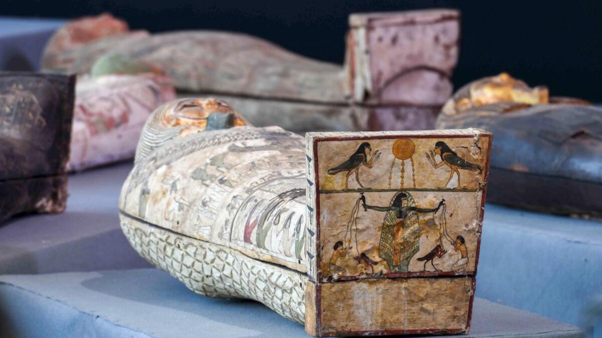 A picture shows wooden sarcophagi during the unveiling of an ancient treasure trove of more than a 100 intact sarcophagi, at the Saqqara necropolis 30 kms south of the Egyptian capital Cairo, on November 14, 2020. Egypt announced the discovery of an ancient treasure trove of more than a 100 intact sarcophagi, the largest such find this year. The sealed wooden coffins, unveiled on site amid fanfare, belonged to top officials of the Late Period and the Ptolemaic period of ancient Egypt. They were found in thr