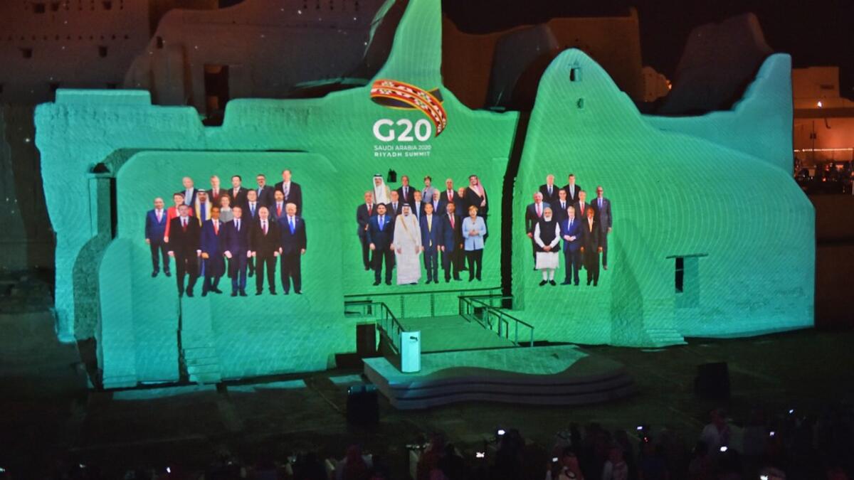 A family photo of G20 Leaders is projected at the historic site of al-Tarif in Diriyah district, on the outskirts of Saudi capital Riyadh, ahead of G20 virtual summit on November 20, 2020. FAYEZ NURELDINE / AFP
