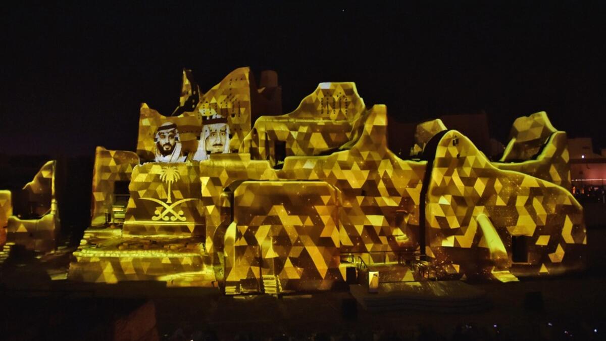 A picture of Saudi King Salman bin Abdulaziz (R) and his son Crown Prince Mohammed bin Salman is projected at the historical site of al-Tarif in Diriyah district, on the outskirts of Saudi capital Riyadh, on November 20, 2020. Saudi Arabia hosts the G20 summit on November 21 in a first for an Arab nation, with the downsized virtual forum dominated by efforts to tackle a resurgent coronavirus pandemic and crippling economic crisis. FAYEZ NURELDINE / AFP