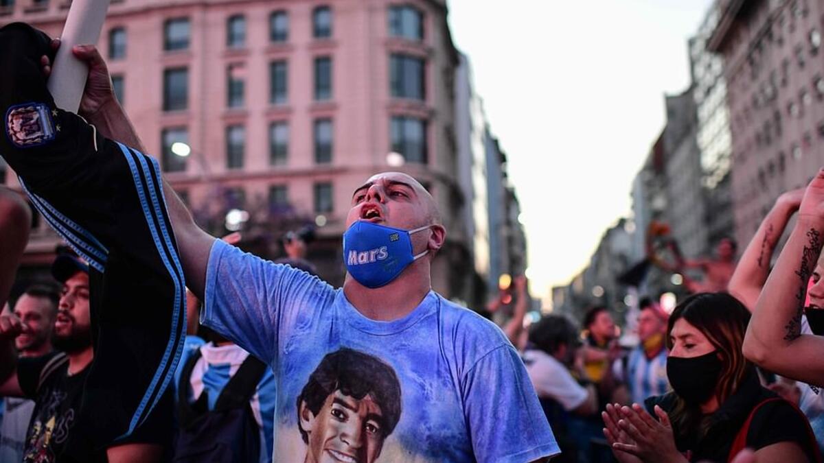 Fans of Argentinian football legend Diego Maradona gather by the Obelisk to pay homage on the day of his death in Buenos Aires. (AFP)