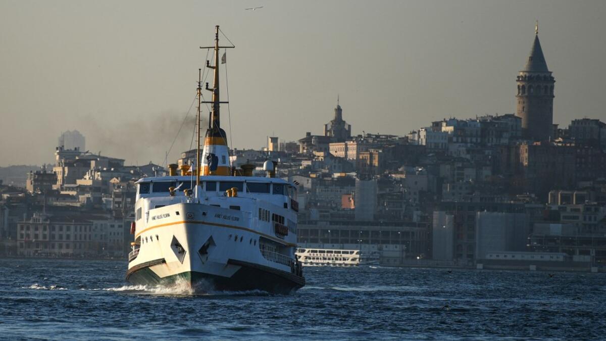 A ferry boat sails on the Bosphorus Strait to the Asia side in Istanbul with the Galata tower seen in the background on November 27, 2020. Ozan KOSE / AFP