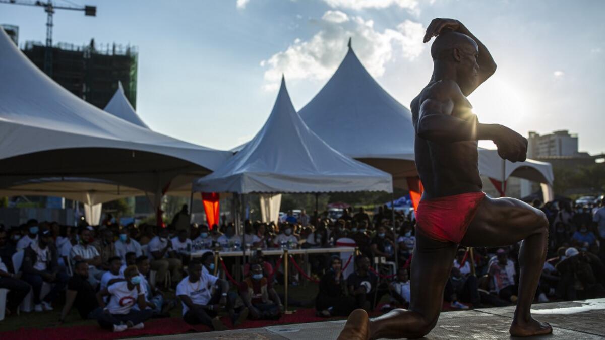 A bodybuilder poses on stage as he takes part in the Iron Fit Bodybuilding competition in Nairobi on December 05, 2020. 130 participants from all across East Africa took part in the second edition of this competition which included categories like Bikini, Figure, Physique and Bodybuilding. Patrick Meinhardt / AFP