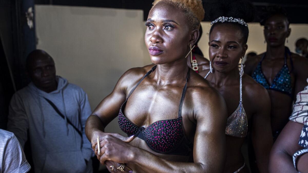 Bodybuilders wait before going on stage during the Iron Fit Bodybuilding competition in Nairobi on December 05, 2020. 130 participants from all across East Africa took part in the second edition of this competition which included categories like Bikini, Figure, Physique and Bodybuilding. Patrick Meinhardt / AFP
