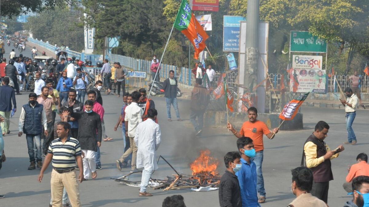 Bharatiya Janata Party supporters block a road during a 12-hour general strike in North Bengal called by BJP to protest against the West Bengal state government in Siliguri on December 8, 2020. Diptendu DUTTA / AFP