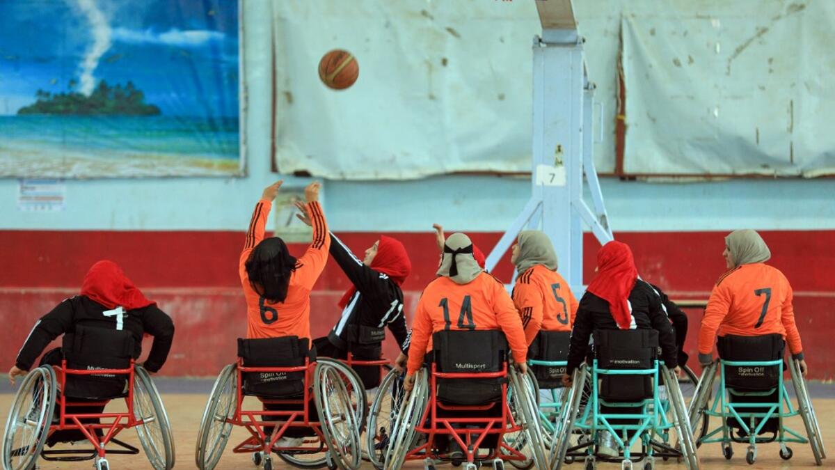 Disabled Yemeni women take part in a local wheelchair basketball championship in Yemen's capital Sanaa on December 8, 2020. In conflict-ridden Yemen, nine teams, including five-all women groups, competed in a local championship for the disabled in the capital Sanaa, which has been under rebel control since 2014. The players are competing to be embraced by society for their strengths rather than be viewed as a burden during the time of war. Mohammed HUWAIS / AFP