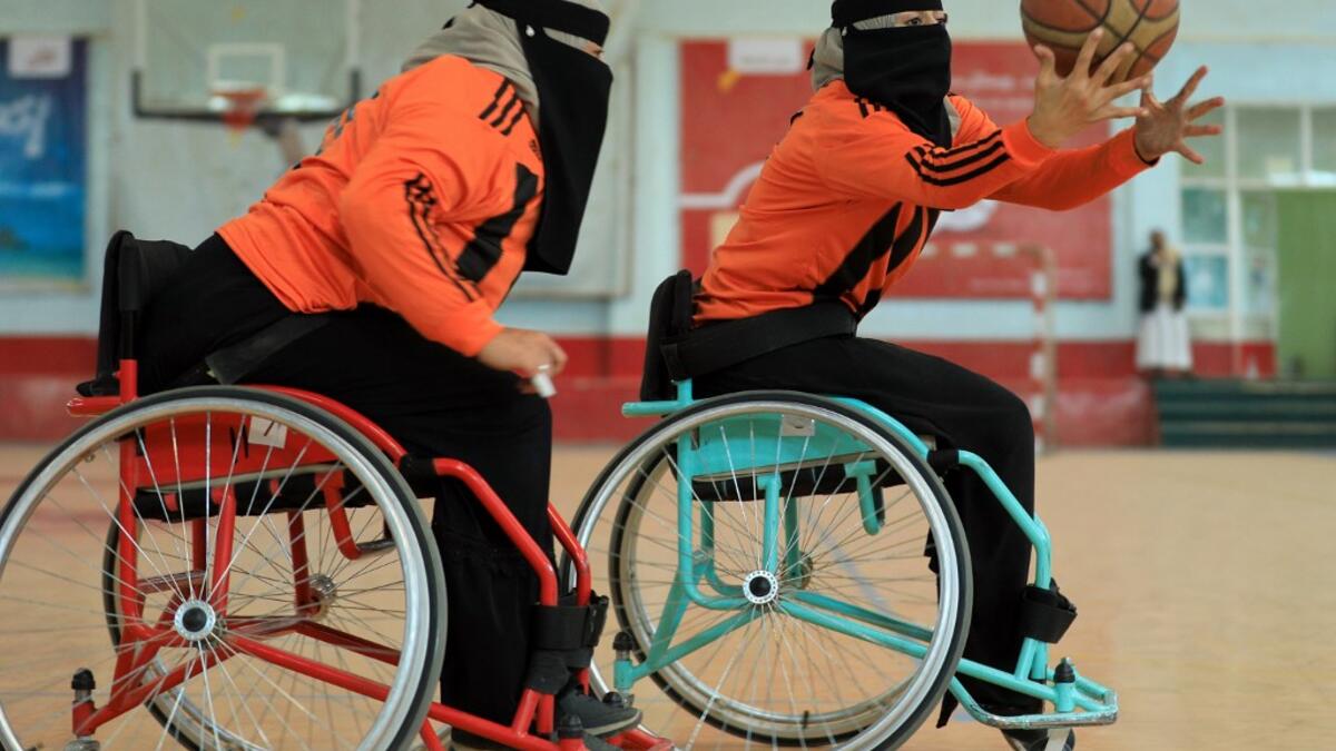 Disabled Yemeni women take part in a local wheelchair basketball championship in Yemen's capital Sanaa on December 8, 2020. In conflict-ridden Yemen, nine teams, including five-all women groups, competed in a local championship for the disabled in the capital Sanaa, which has been under rebel control since 2014. The players are competing to be embraced by society for their strengths rather than be viewed as a burden during the time of war. Mohammed HUWAIS / AFP