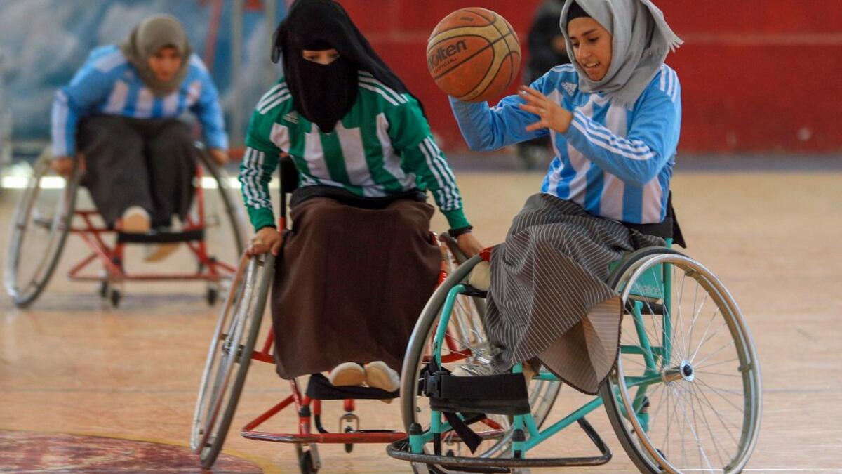 Disabled Yemeni women take part in a local wheelchair basketball championship in Yemen's capital Sanaa on December 8, 2020. In conflict-ridden Yemen, nine teams, including five-all women groups, competed in a local championship for the disabled in the capital Sanaa, which has been under rebel control since 2014. The players are competing to be embraced by society for their strengths rather than be viewed as a burden during the time of war. Mohammed HUWAIS / AFP