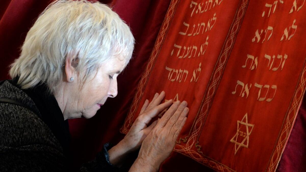 In this file photo taken on March 6, 2015, Fanny Mergui, a Moroccan Jewish woman, meditates as she visits Casablanca's Moroccan Jewish museum. Jewish history and culture in Morocco will now be part of the school curriculum -- a "first" in the region and in the North African country, where Islam is the state religion. Morocco's Jewish community has been present since antiquity and grew over the centuries, particularly with the arrival of Jews expelled from Spain by the Catholic kings after 1492. Fadel SENNA