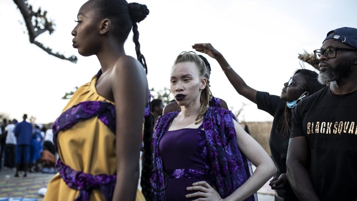 Fashion models wait backstage before heading out onto the runway during Dakar Fashion Week in Dakar on December 12, 2020. JOHN WESSELS / AFP