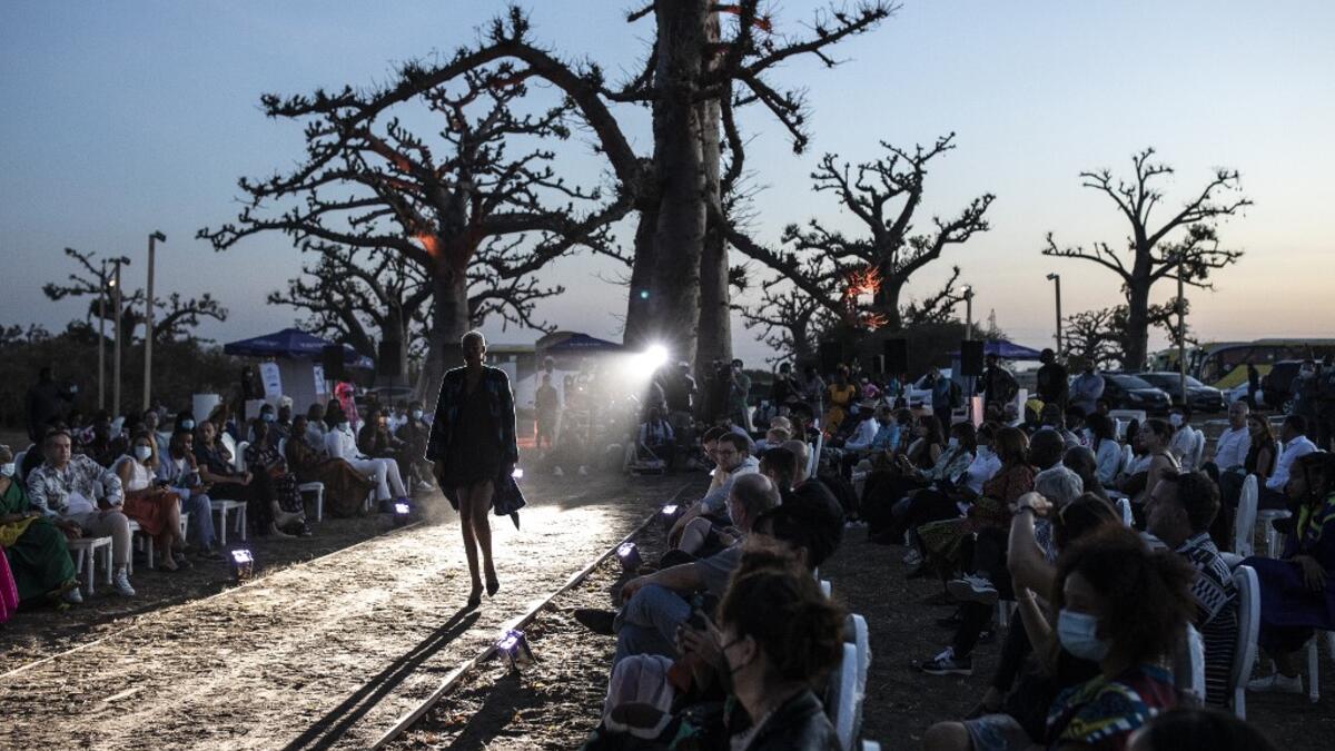 A fashion model walks down the runway during Dakar Fashion Week in Dakar on December 12, 2020. JOHN WESSELS / AFP