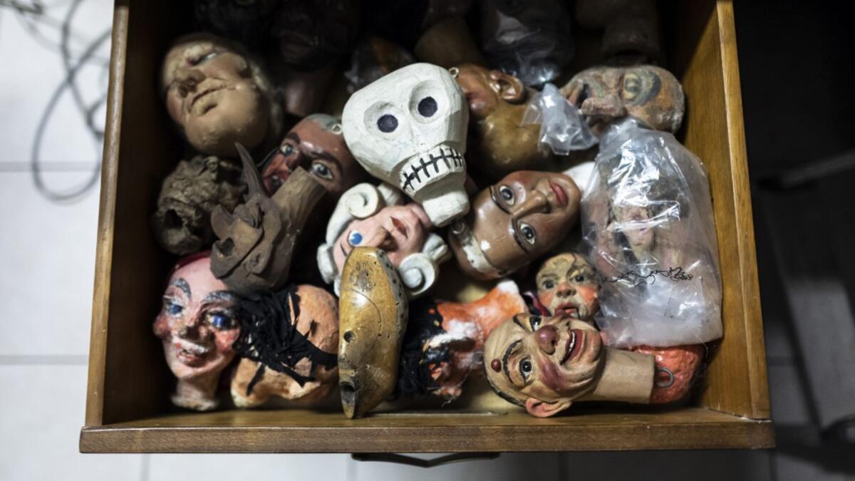 Puppet heads lies in a drawer at the " Alfa Theatre" laboratory in Turin, on November 30, 2020. The Grilli family has a collection of more than 20,000 objects from around the world, everything from theatres, marionettes and glove puppets to shadow figures and silhouettes. A long-time dream of Grilli and his wife Mariarosa, 78, the museum is due to open in 2023 in Turin, financed both privately and publicly with the help of different institutions.  Marco Bertorello / AFP