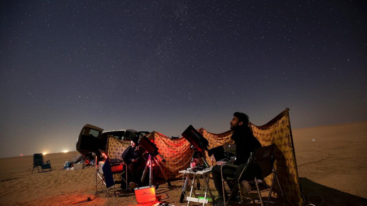 Kuwaiti astrophotographers follow the great conjunction between Jupiter and Saturn in al-Salmi district, a desert area 120 kms west of Kuwait City, on December 21, 2020. The great conjunction refers to the alignment of Jupiter and Saturn. YASSER AL-ZAYYAT / AFP