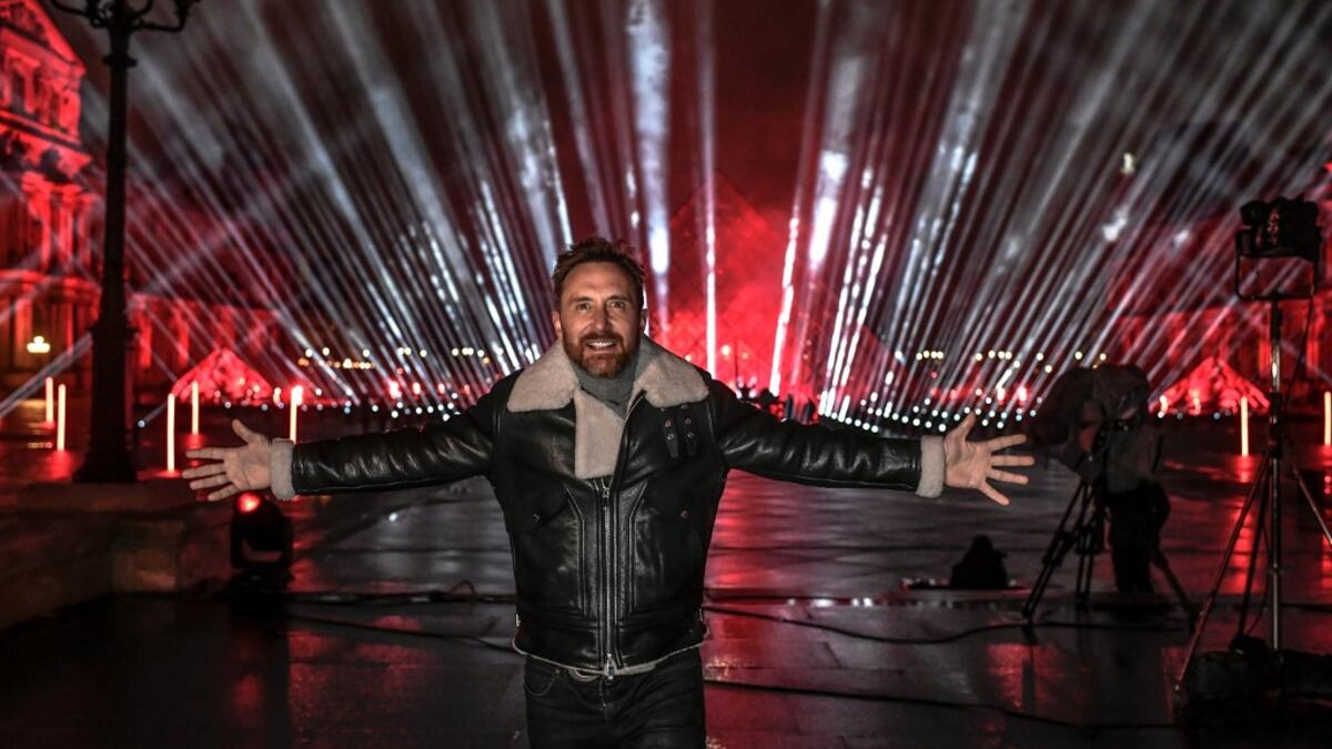 French DJ David Guetta poses on the stage set up for his 2021 New Year's eve livestream charity concert "United at Home", in the Cour Napoleon, in front of the Louvre Pyramid, in Paris, on December 29, 2020, amid the Covid-19 (novel coronavirus) pandemic. STEPHANE DE SAKUTIN / AFP