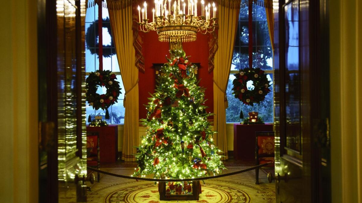 A Christmas tree and decorations are on display in the Red Room of the White House on November 30, 2020 in Washington, DC. This year's theme for the White House Christmas decorations is "America the Beautiful." Drew Angerer/Getty Images/AFP