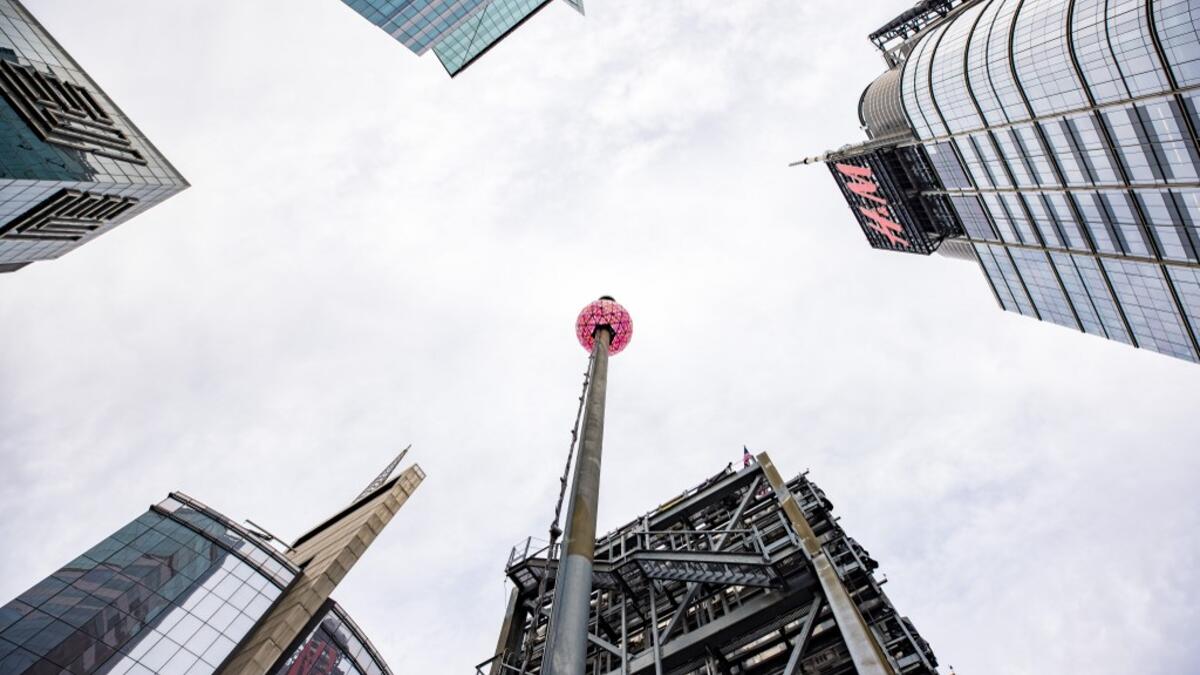 The world famous Times Square crystal ball is illuminated and elevated for a final test, a day ahead of the New Year's Eve celebrations at Time Square, on December 30, 2020 in New York City. Angela Weiss / AFP
