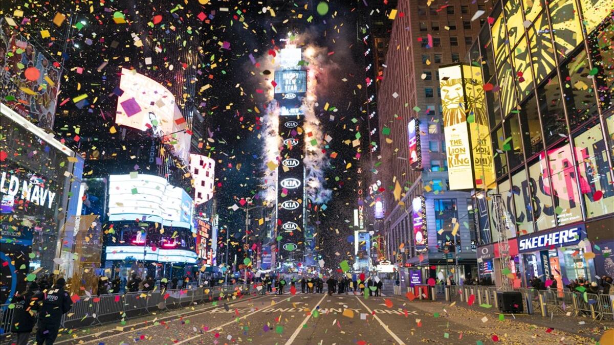 Confetti are flying in the air on a mostly empty Times Square for New Year’s Eve in New York City on January 1, 2021. Due to the Coronavirus outbreak Times Square is closed to all but a few revelers. COREY SIPKIN / AFP