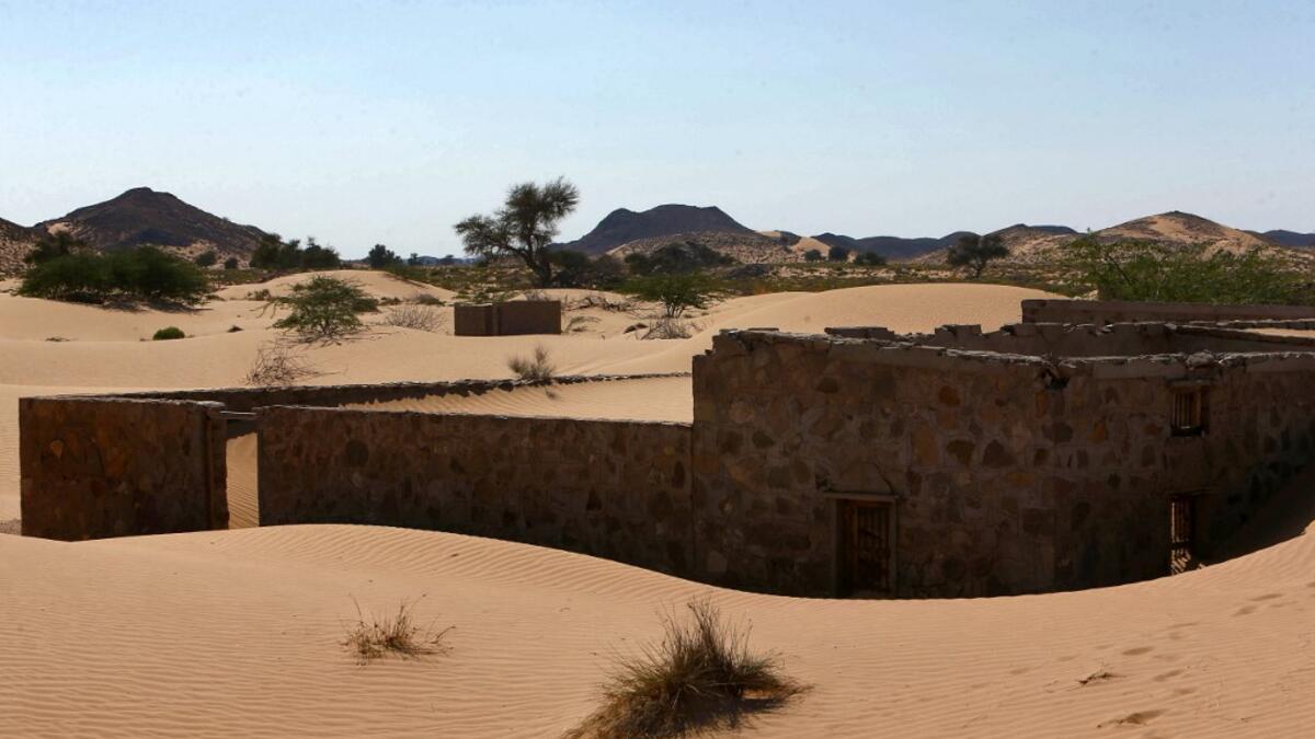 This picture taken on December 31, 2020, shows the walls of an abandoned house in the Omani village of Wadi al-Murr, about 400 kms (250 miles) southwest of the capital Muscat. Encroaching desert sands have left little evidence that Wadi al-Murr ever existed, but former inhabitants, while resigned to its destruction, are trying to preserve its memory. MOHAMMED MAHJOUB / AFP