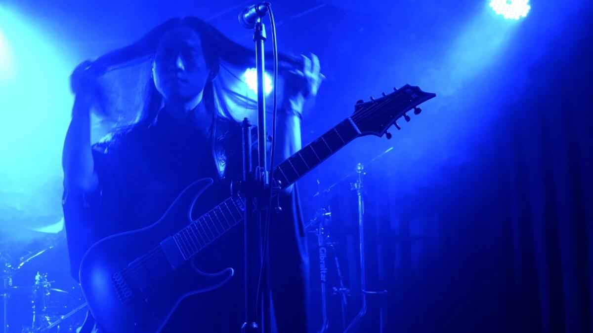 This picture taken on December 3, 2020 shows Andy Lin, a guitarist of Taiwanese death metal band 'Dharma' fixing his hair during a rehearsal in Taipei. Sam Yeh / AFP