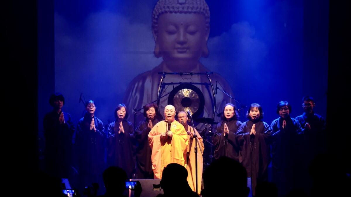 This picture taken on January 2, 2021 shows Buddhist nun Miao-ben (C), a vocalist of Taiwanese death metal band 'Dharma' performing during a concert in Taichung. Sam Yeh / AFP