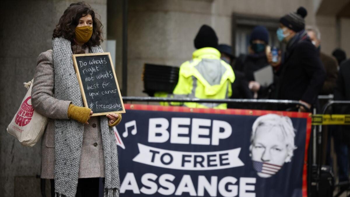 Supporters of Wikileaks founder Julian Assange demonstrate outside the Old Bailey court in central London as the court will rule on his extradition case on January 4, 2021. A London hearing is set to decide if WikiLeaks founder Julian Assange should be extradited to the United States to face trial over the publication of secrets relating to the wars in Afghanistan and Iraq. Tolga Akmen / AFP