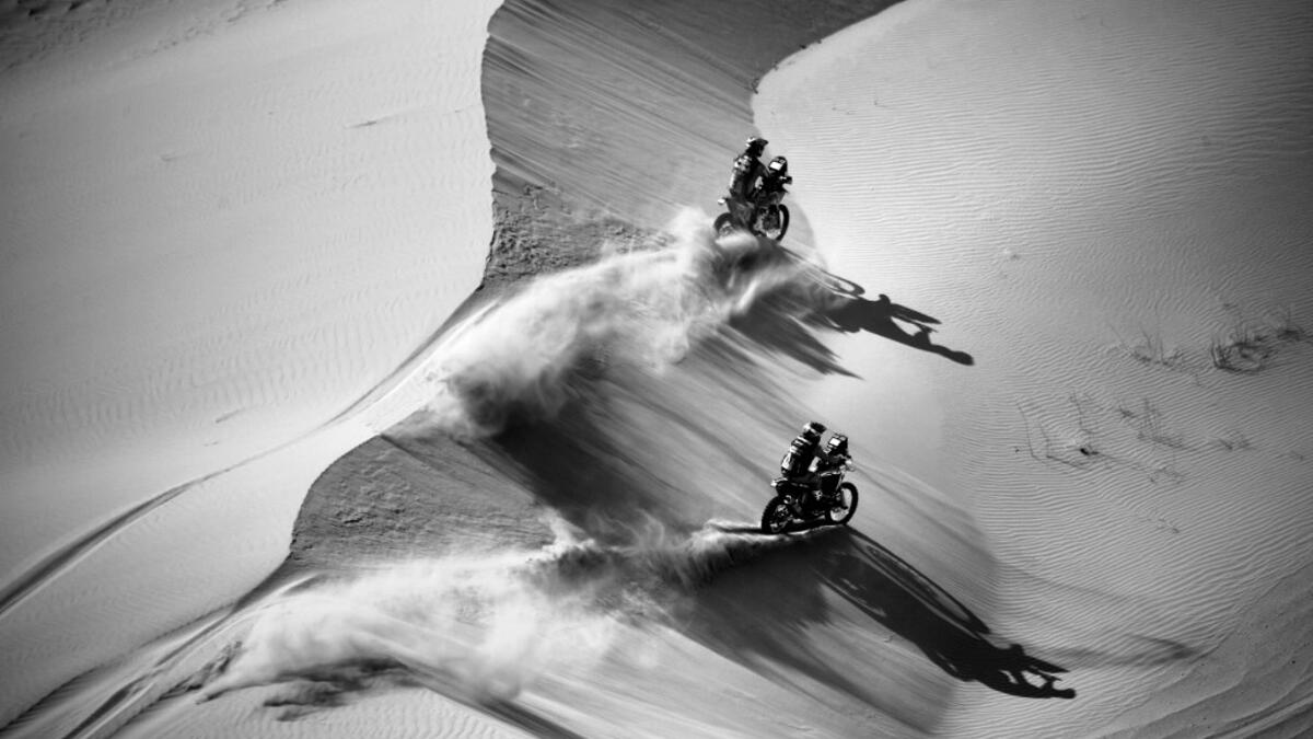 Australian biker Toby Price (top) and Argentinian biker Kevin Benavides compete during Stage 4 of the Dakar Rally 2021 between Wadi Ad-Dawasir and Saudi Arabia's capital Riyadh, on January 6, 2021. FRANCK FIFE / AFP