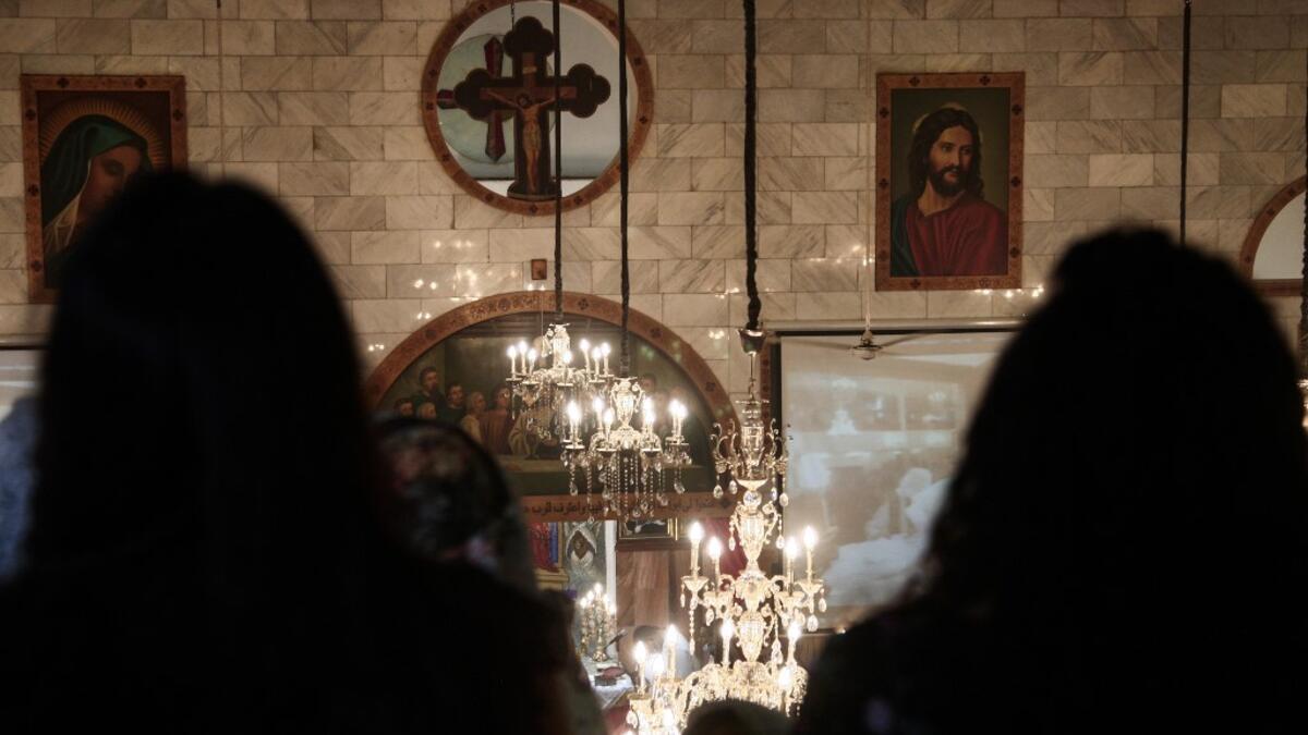 Sudanese Copts attend Christmas midnight mass at the capital Khartoum's Martyrs Church late on January 6, 2021, as the Orthodox Christian faith uses the old Julian calendar in which Christmas falls 13 days after the date in the more widespread Gregorian calendar.  Ebrahim HAMID / AFP
