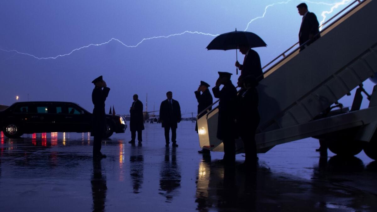 AFP presents a retrospective photo package of 60 pictures marking the 4-year presidency of President Trump. US President Donald Trump disembarks from Air Force One as lightning splits the sky during a storm at Joint Base Andrews in Maryland, August 28, 2020. SAUL LOEB / AFP