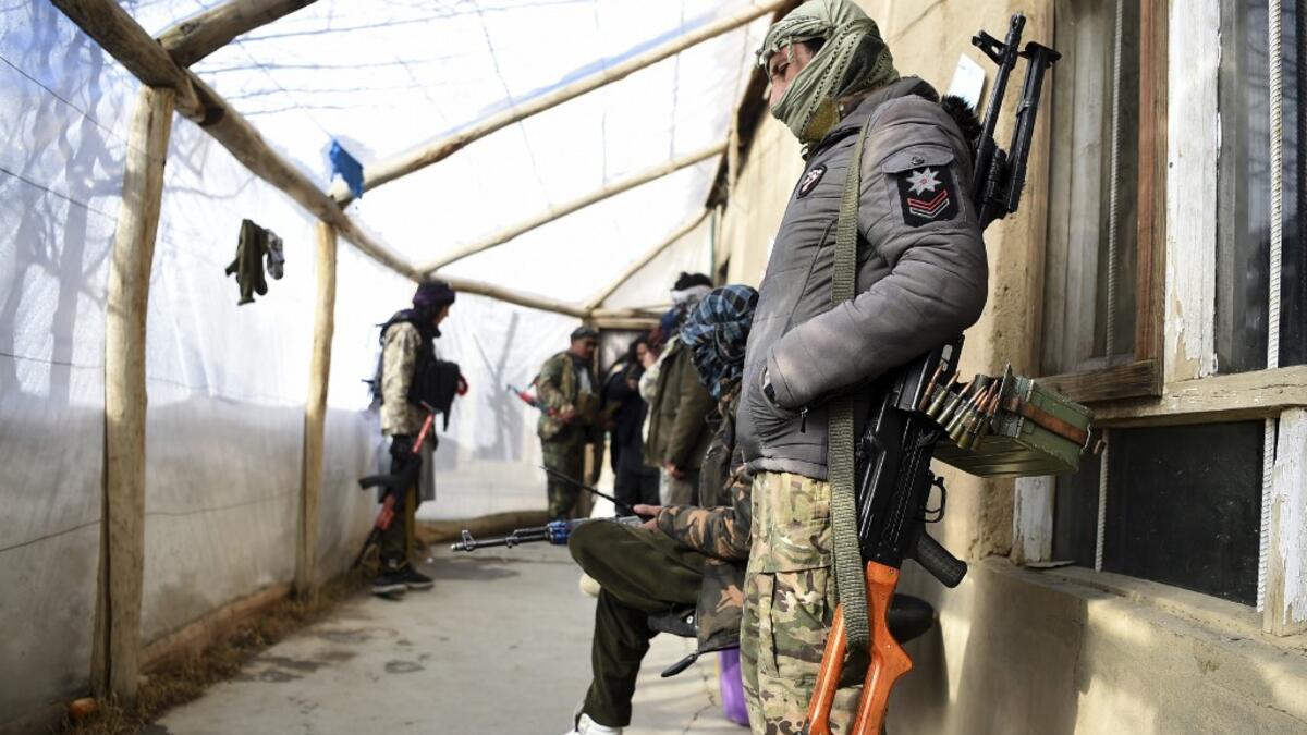 In this photo taken on January 9, 2021, Hazara armed militia for the Resistance for Justice Movement, stand inside their base ahead of a patrol against Taliban insurgents at Hisa-e-Awali Behsud district of Maidan Wardak Province. Comprising roughly 10 to 20 percent of Afghanistan's 38-million population, Hazaras have long been persecuted for their largely Shiite faith by Sunni hardliners in a country wracked by deep ethnic divisions. WAKIL KOHSAR / AFP