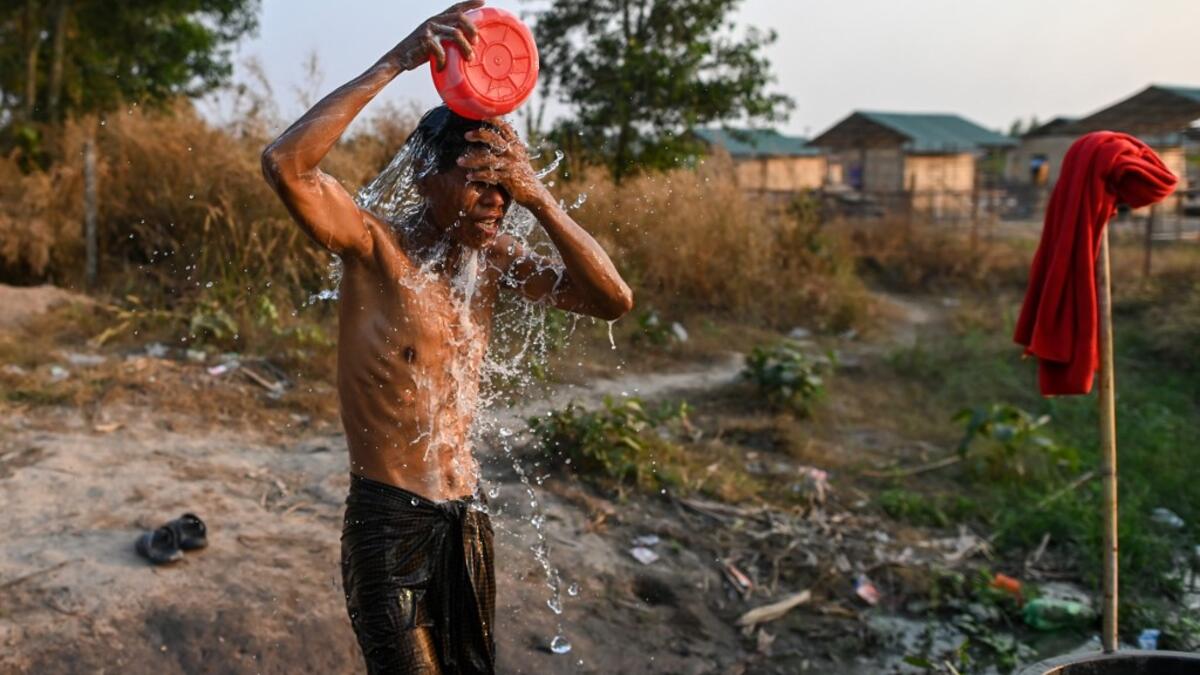 This photo taken on January 11, 2021 shows a Chin man washing in Bethel village in Hmawbi, on the outskirts of Yangon, where hundreds of members of the Chin ethnic community have settled after being displaced by fighting between Myanmar's military and the Arakan Army in the country's north.  Ye Aung THU / AFP