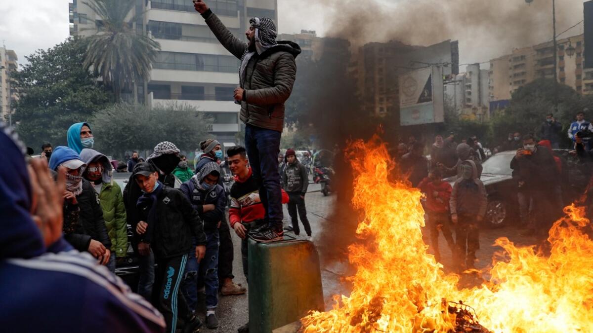 Lebanese anti-government protesters burn garbage as they go around the homes of deputies and government officials in the northern port city of Tripoli to protest the economic situation and their role in leading the country to crisis, on January 28, 2021. Tripoli was already one of Lebanon's poorest areas before the coronavirus pandemic piled new misery onto a chronic economic crisis. Many of its residents have been left without an income since Lebanon imposed a full lockdown earlier this month in a bid to s