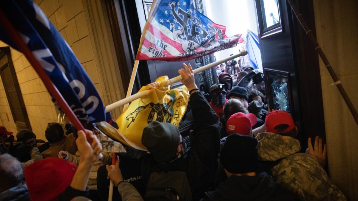 A pro-Trump mob breaks into the U.S. Capitol on January 06, 2021 in Washington, DC. Congress held a joint session today to ratify President-elect Joe Biden's 306-232 Electoral College win over President Donald Trump. A group of Republican senators said they would reject the Electoral College votes of several states unless Congress appointed a commission to audit the election results. Win McNamee/Getty Images/AFP