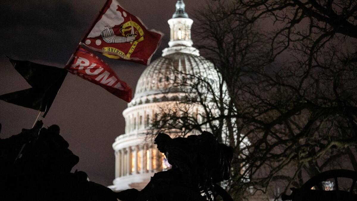 A Trump flag flies over the grounds of the U.S. Capitol on January 06, 2021 in Washington, DC. A pro-Trump mob stormed the Capitol earlier, breaking windows and clashing with police officers. Trump supporters gathered in the nation's capital to protest the ratification of President-elect Joe Biden's Electoral College victory over President Donald Trump in the 2020 election. John Moore/Getty Images/AFP