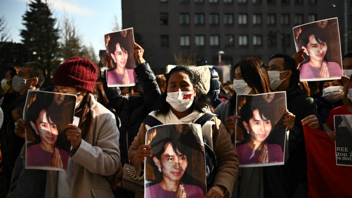 A group of Myanmar activists hold the portrait of Aung San Suu Kyi during a protest outside the United Nation university in Tokyo on February 1, 2021 following a military coup in the country by a general after arresting civilian leader Aung San Suu Kyi and other senior officials. Philip FONG / AFP