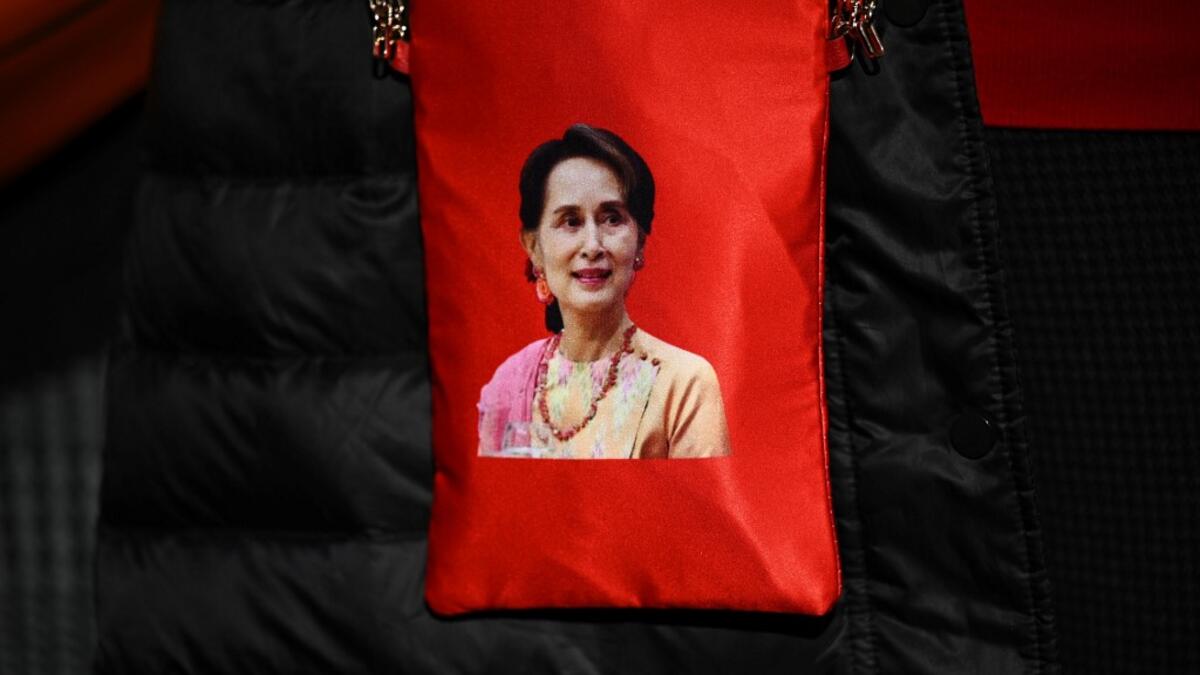 A portrait of Myanmar's de facto leader Aung San Suu Kyi is seen on a bag as Myanmar activists protest outside the United Nations university building in Tokyo on February 1, 2021 following a military coup in the country by a general after arresting civilian leader Aung San Suu Kyi and other senior officials. Philip FONG / AFP