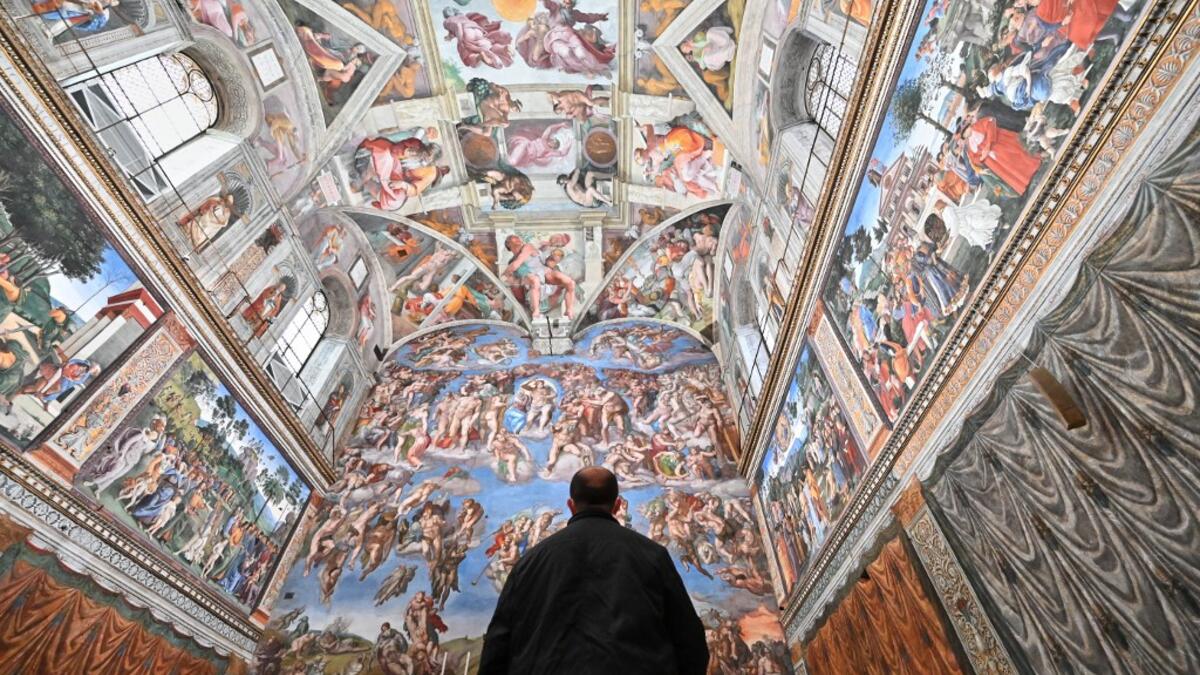 A man visits the Sistine Chapel on the reopening day of the Vatican museum on February 1, 2021 in Vatican City, as the city-state eases its closure aimed at curbing the spread of the COVID-19 infection, caused by the new coronavirus. Andreas SOLARO / AFP