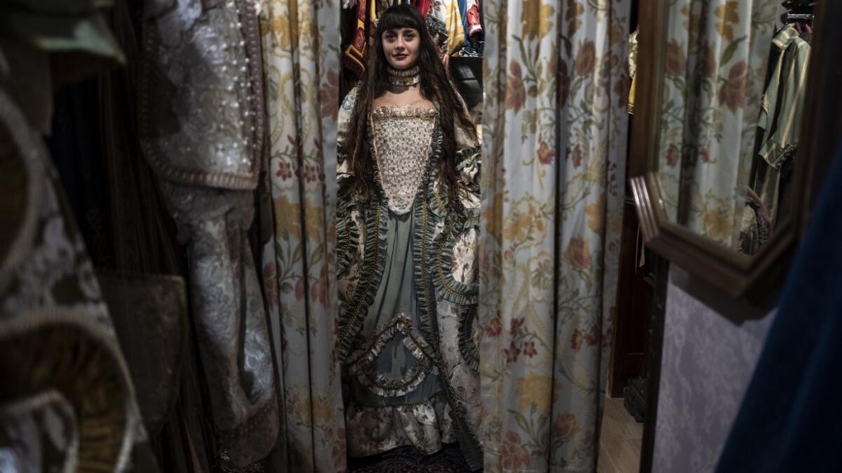 A reveller poses with a traditional carnival costume in 'La Bauta' shop in Venice on February 6, 2021, as the traditional Venice carnival is being cancelled due to the Covid-19 pandemic. Marco Bertorello / AFP