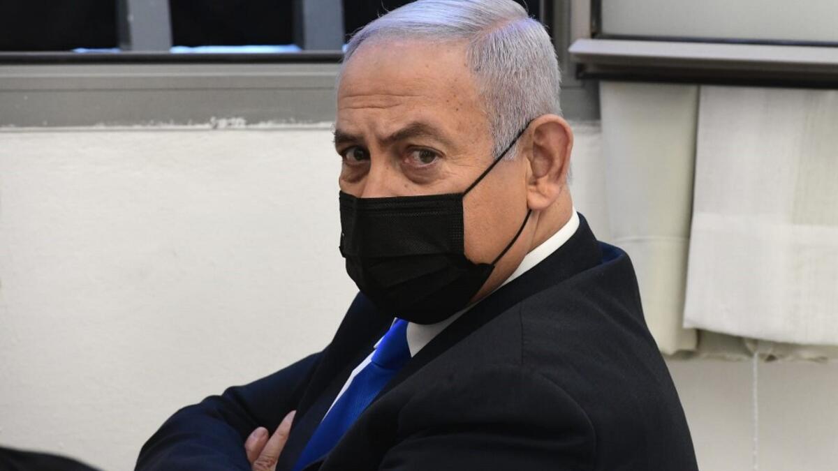 Israeli Prime Minister Benjamin Netanyahu looks on ahead of a hearing in his corruption trial at the Jerusalem district court, on February 8, 2021. Israel's Prime Minister Benjamin Netanyahu returns to court to formally respond to the corruption charges against him, as his trial enters an intensified phase six weeks before he faces re-election. POOL / AFP
